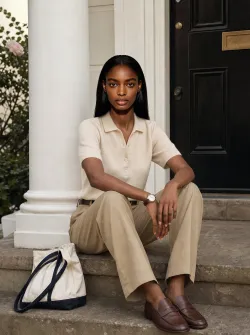 Black woman, 25–35 years old, warm medium-dark skin tone, oval face shape, symmetrical features, high cheekbones, full lips, straight black hair, shoulder-length, athletic yet feminine body type, natural and confident model look.