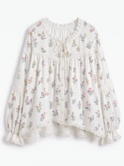 Female, wearing a white floral - printed blouse with a sweet style. It has a lace - trimmed round neck, tied with a bow, puff sleeves and multiple lace trims. The fabric is assumed to be soft cotton.